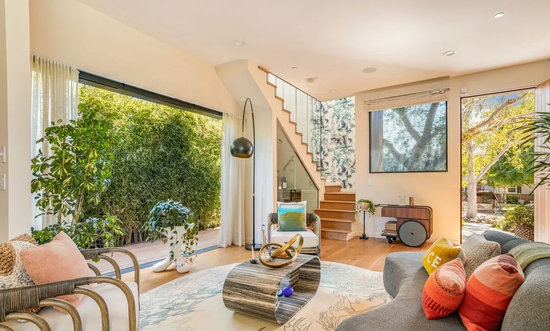 Living room with a floating stair and garden windows