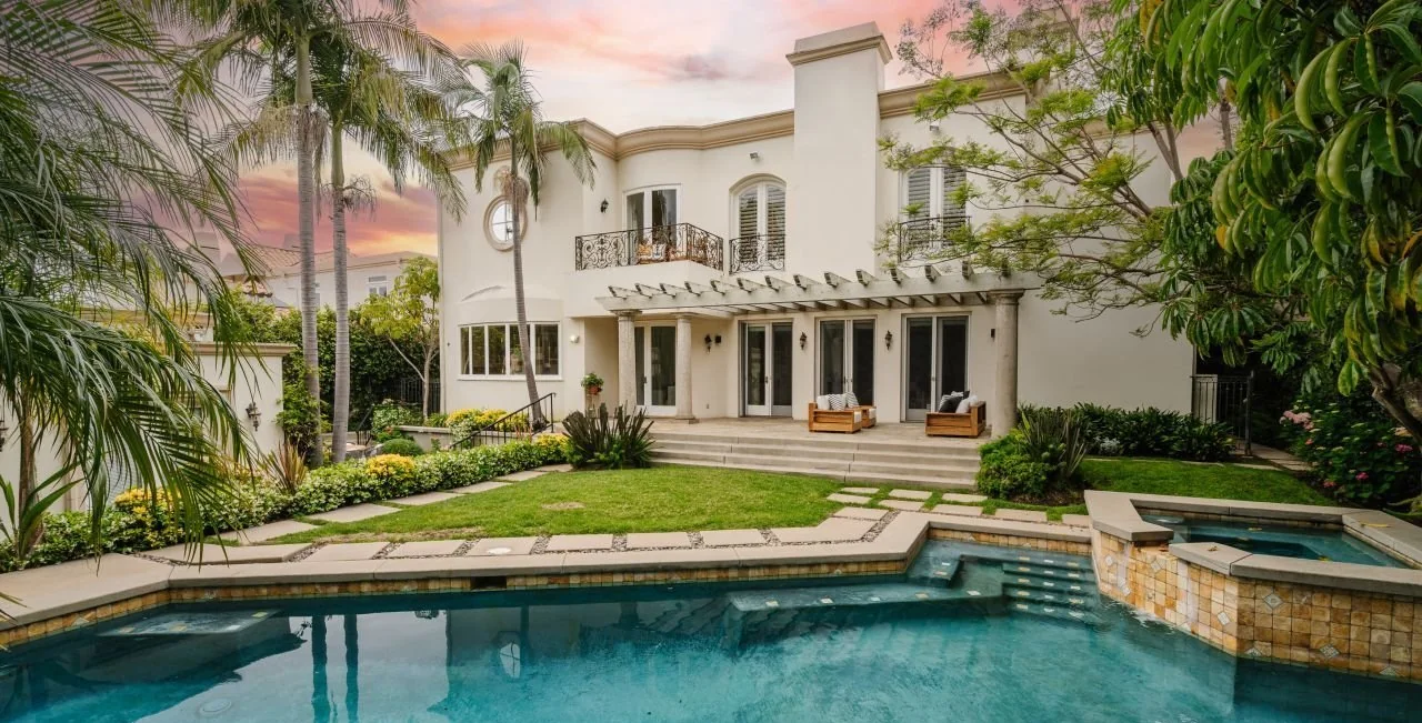 Rear garden and pool of 510 North Crescent Drive at dusk