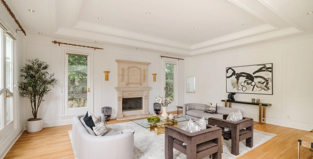 Living room with a carved stone fireplace