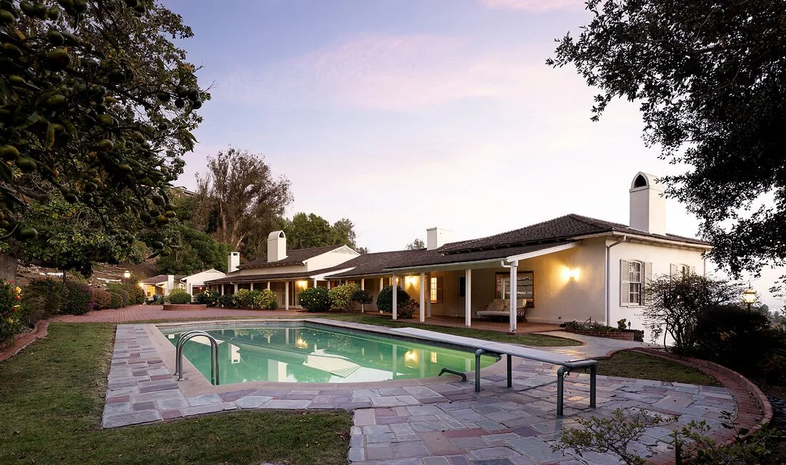 Pool and flagstone terrace at dusk